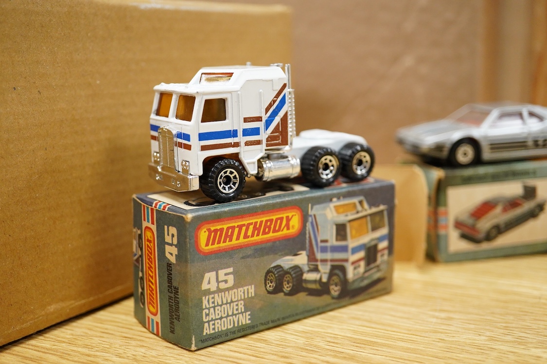 Twelve boxed Matchbox Superfast and Rola-matics 1-75 vehicles; VW Golf (7), petrol tanker (14), Badger (16), Blaze Buster (22), Atlas truck (23), diesel shunter (24), flat car with container (25), passenger coach (44), K